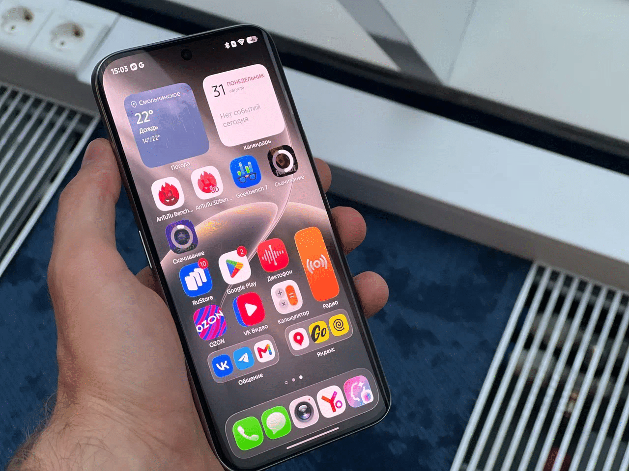 Главный экран HiOS 16 с виджетами на смартфоне TECNO в руке