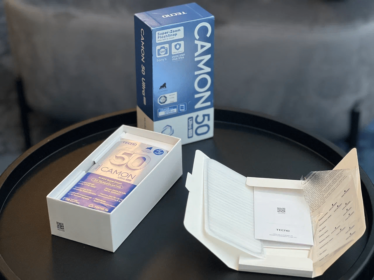 Распакованная коробка TECNO CAMON 50 Ultra 5G с конвертом аксессуаров